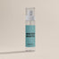 The Winter Mantel Room Spray shot on a dark cream background.