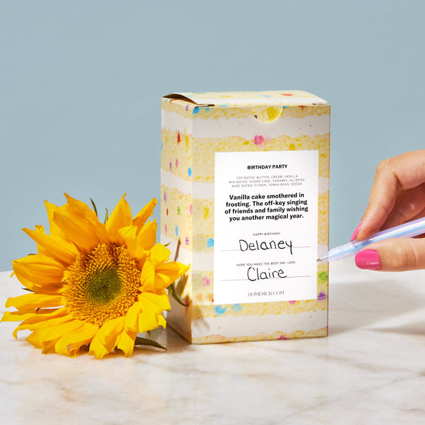 The back packaging of the candle where one can write in who the gift is for and from.