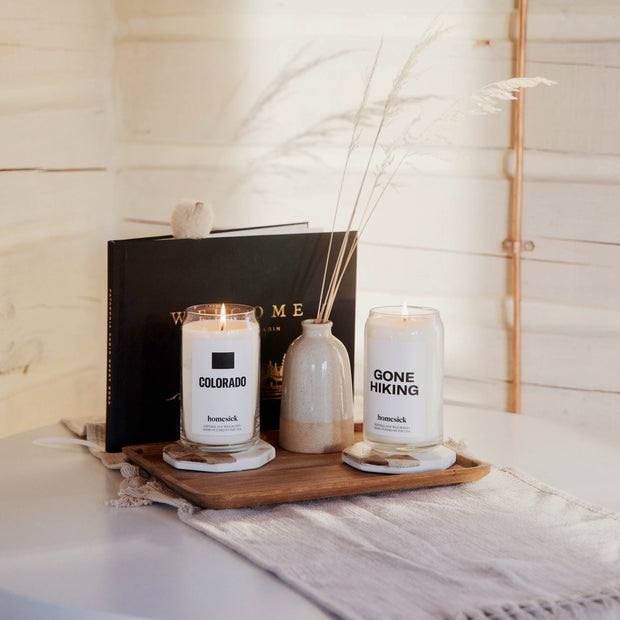 Gone Hiking and Colorado candle in a cozy setting.