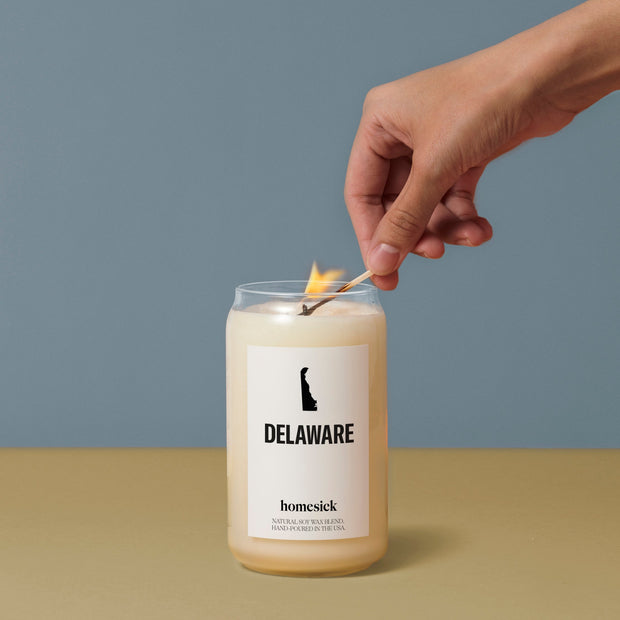 Someone lighting the Delaware candle with a match.