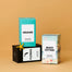 A group product shot of coastal inspired homesick candles shot on a light sand background.