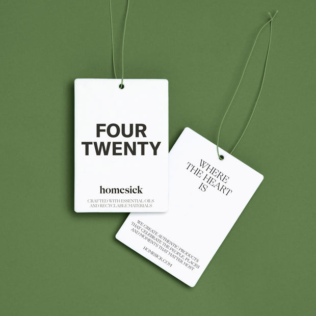 The front and back of the Four Twenty Car Freshener shot on a green background.