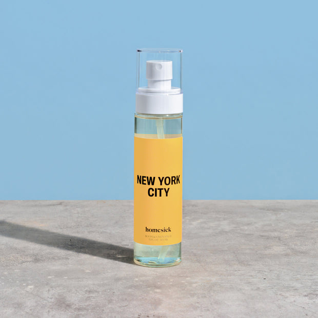 A product shot of the New York City Linen/Room Spray shot on a dark cream background.
