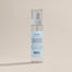 A product shot that shows the back labeling of the New Home Room Spray.
