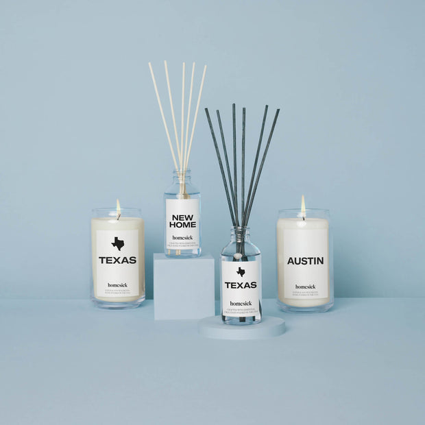 A group product shot of all the Texas inspired candles and reed diffusers available at Homesick. All shot in a light blue studio environment.