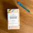 AN overhead shot of the Thanks Candle that shows the back of the packaging and how a custom note can be written.